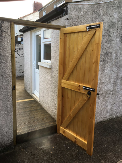 Timber gate with black powder coated ironmongery